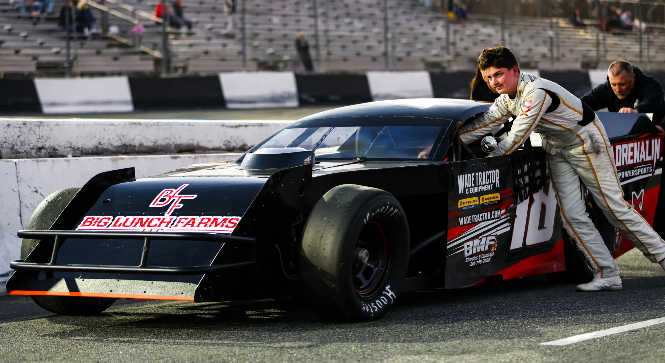 Matthew Laprade standing next to his race car