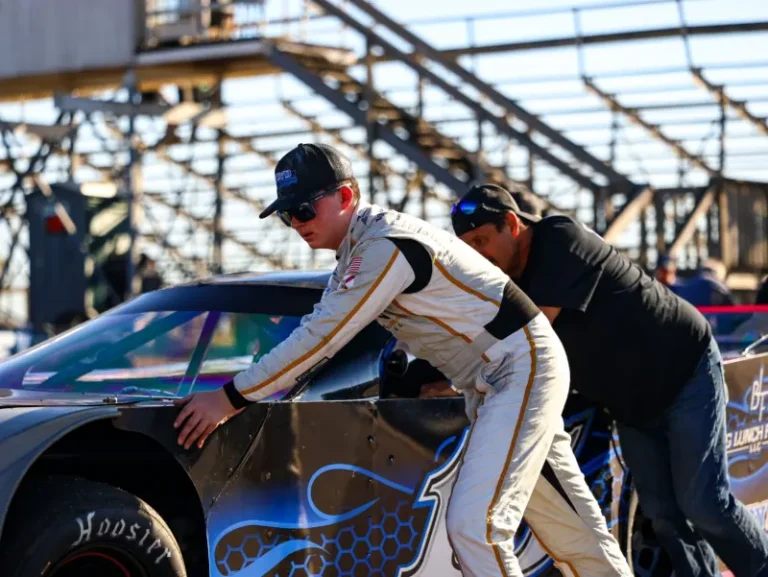 Matthew pushing race car in pit